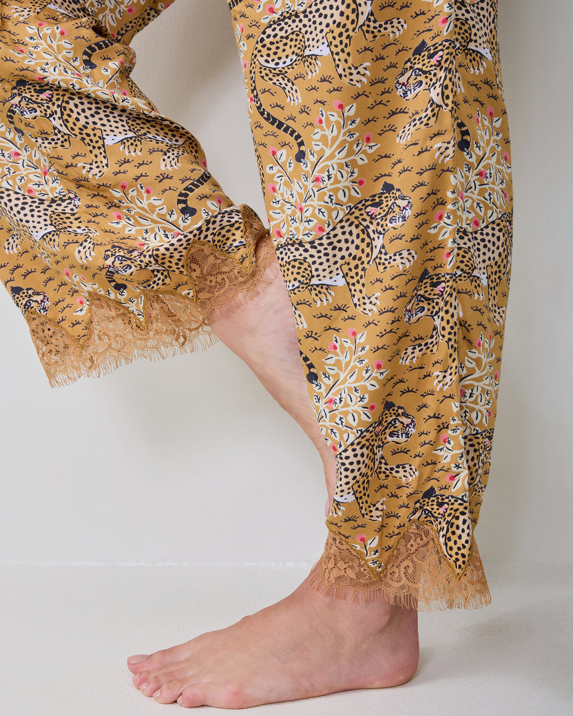 Close-up of the Bagheera Tobacco Jackie pajama pants showing the leopard-and-floral print and lace-trimmed hems.
