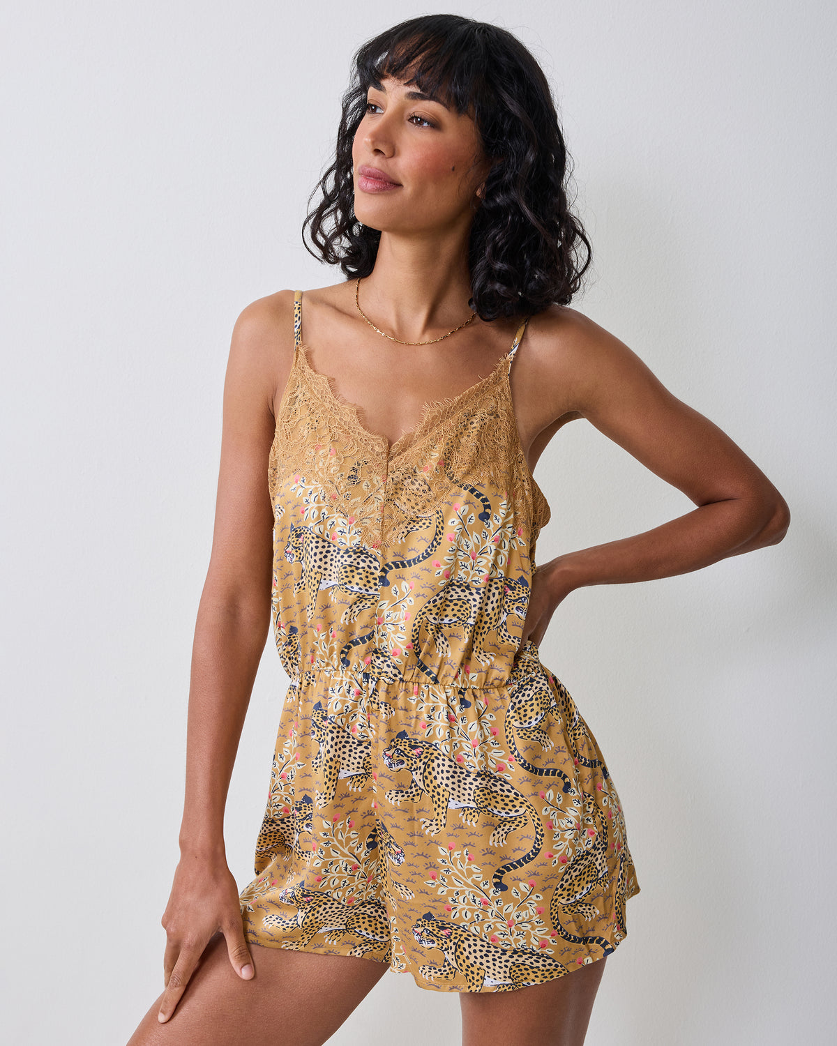 Bagheera tobacco lace romper shown from the front with thin straps, lace neckline, elastic waist, and shorts-length legs.