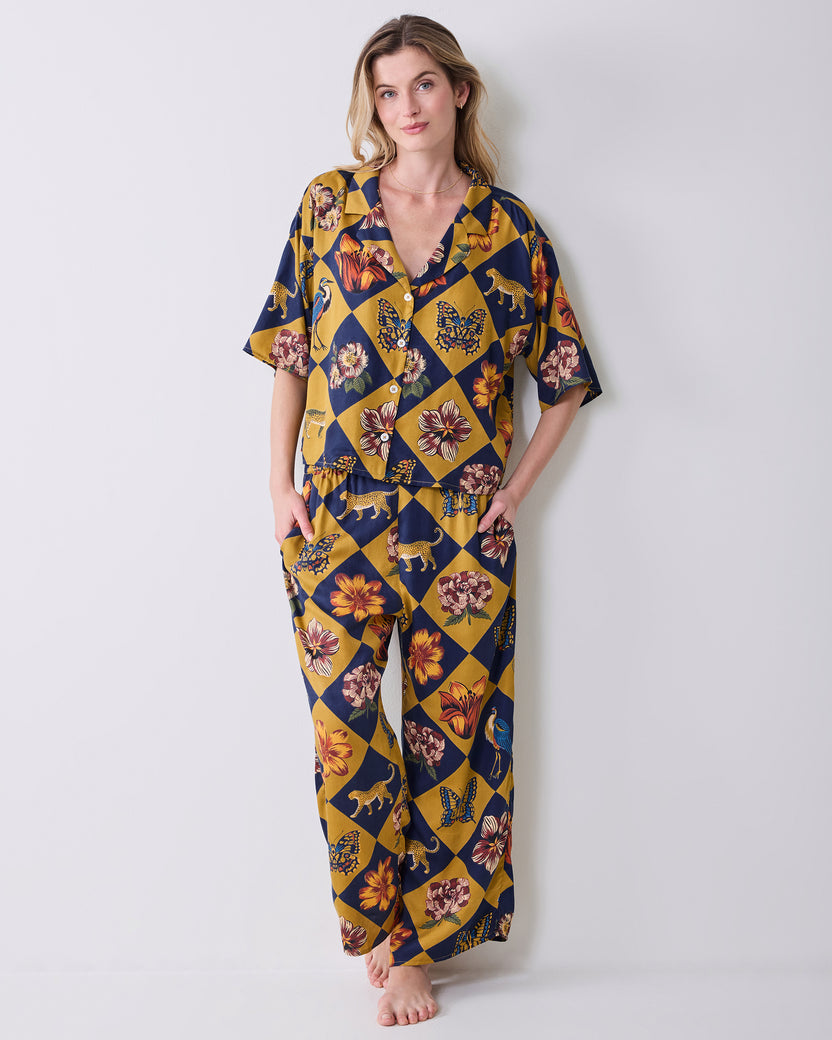 Full-length front view of a person wearing the Golden Hour Botanical Checkerboard short-sleeved top and matching wide-leg pants.