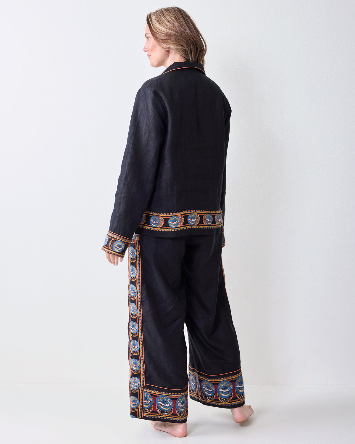 Back view of the Addison pajama set showing patterned trim across the top hem, cuffs, and pant hems.