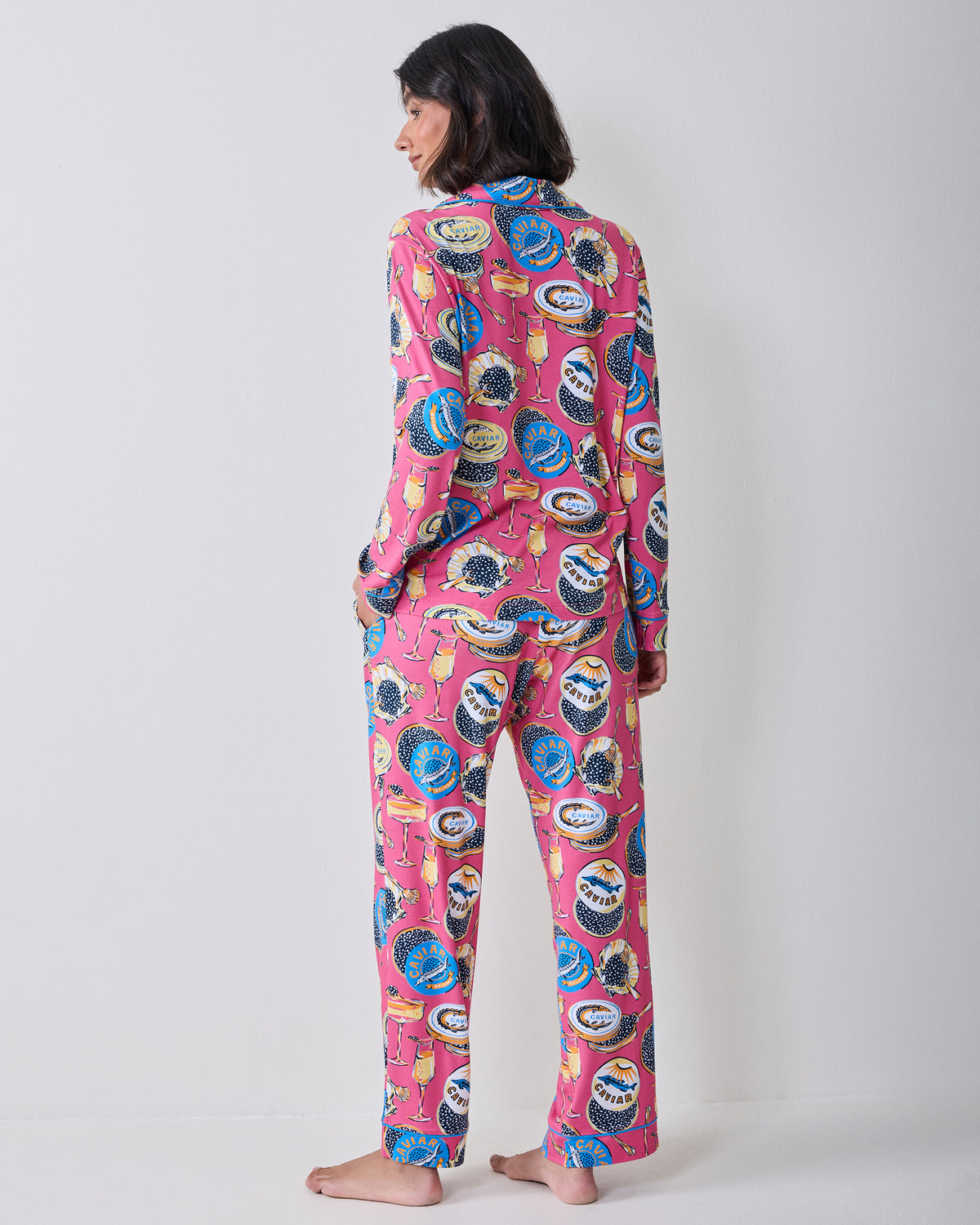 Back view of the hot pink Champagne & Caviar long pajama set showing the printed top and straight-leg pants.