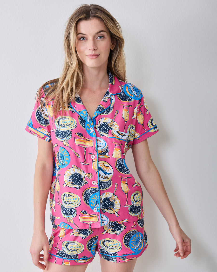 Front view of the hot pink Champagne & Caviar short pajama set with a button-front top and shorts.