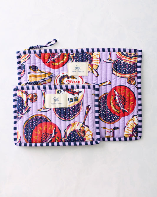 Two lavender Champagne & Caviar flat pouches with striped trim, overlapping to show both sizes.