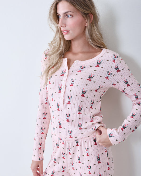 Close view of the blush Kaylee pajama set, showing a long-sleeve henley top and matching pants with small Christmas-themed motifs.
