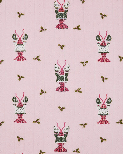 Close-up fabric swatch showing the Christmas Claws repeating red, green, and white crustacean print on a pink background.