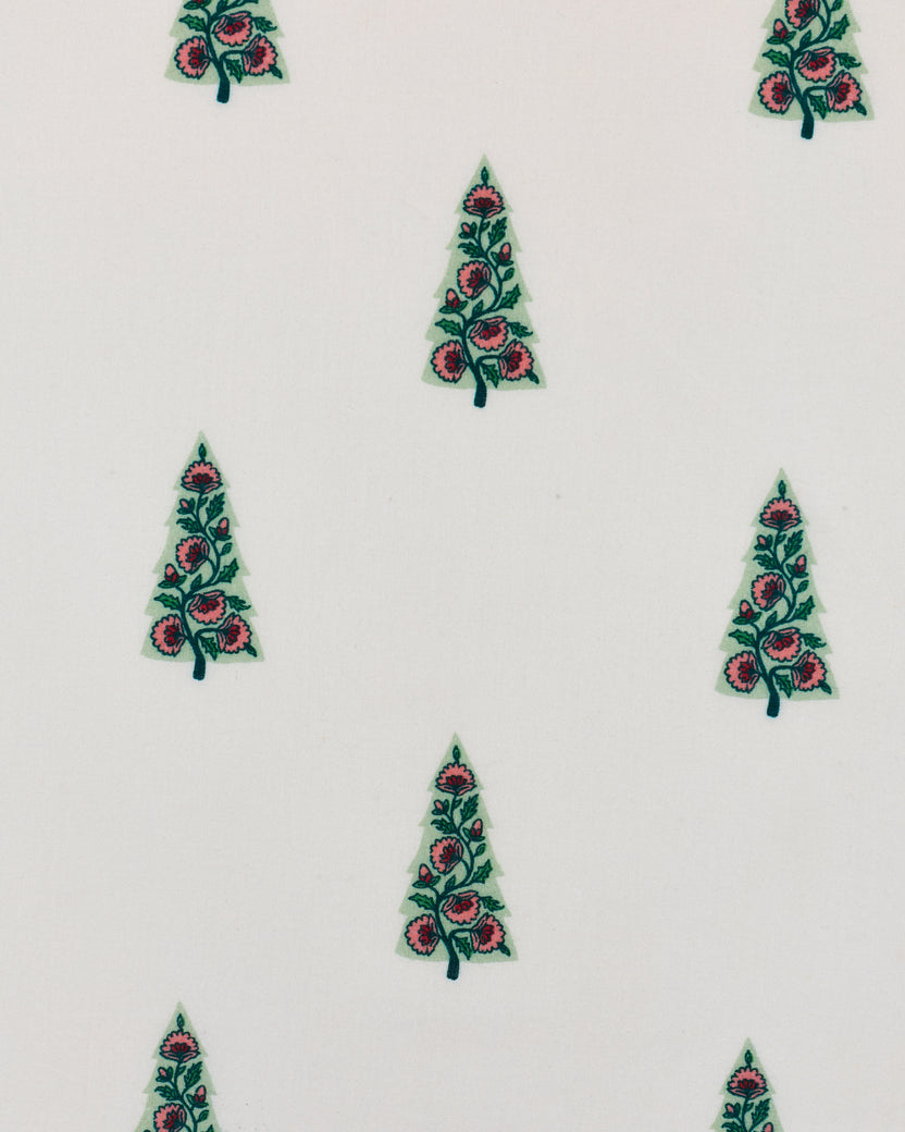 Close-up of the nightgown’s repeated floral tree print on a pale background.
