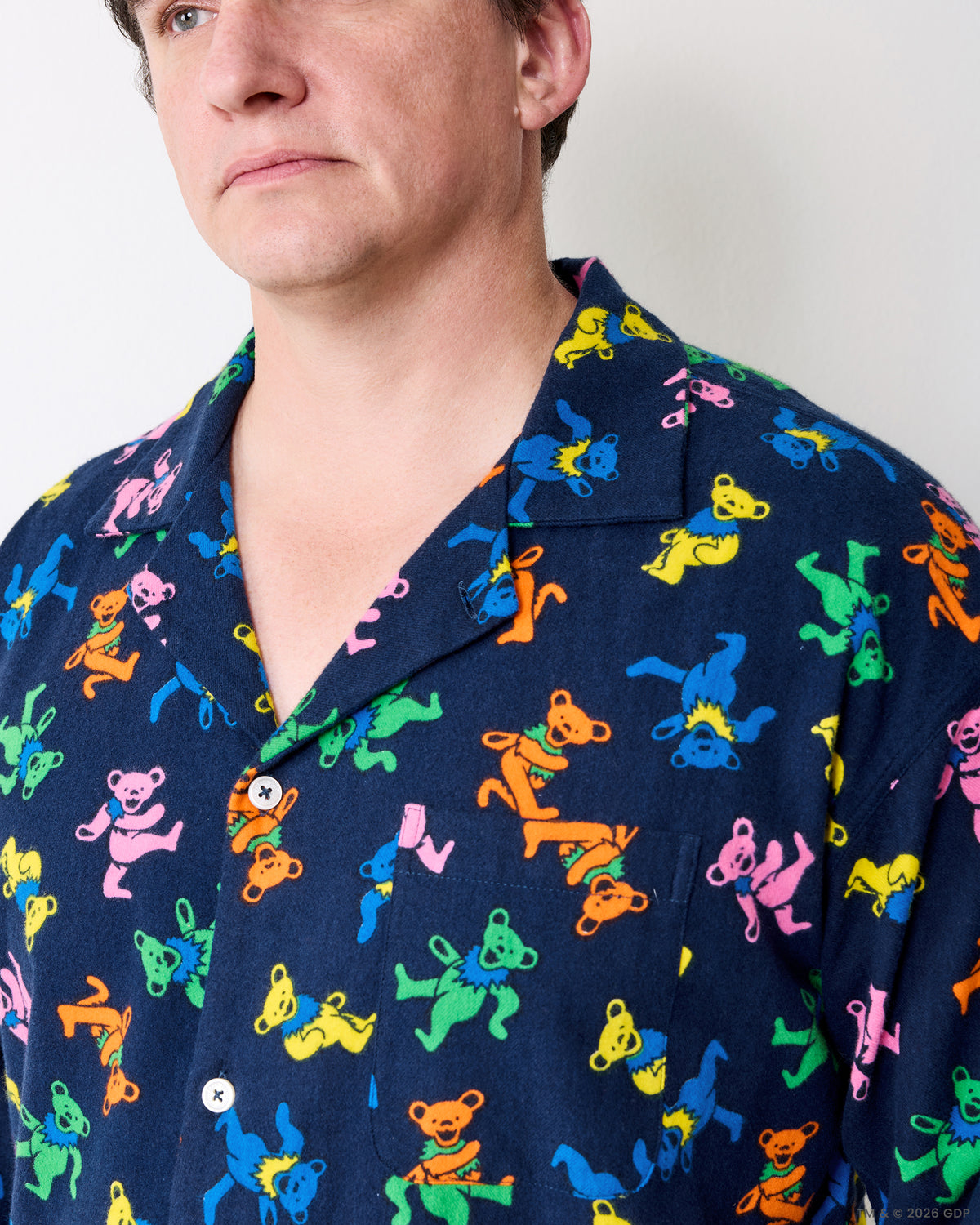 Close-up of the Dancing Bears men's pajama shirt collar, buttons, and printed fabric.