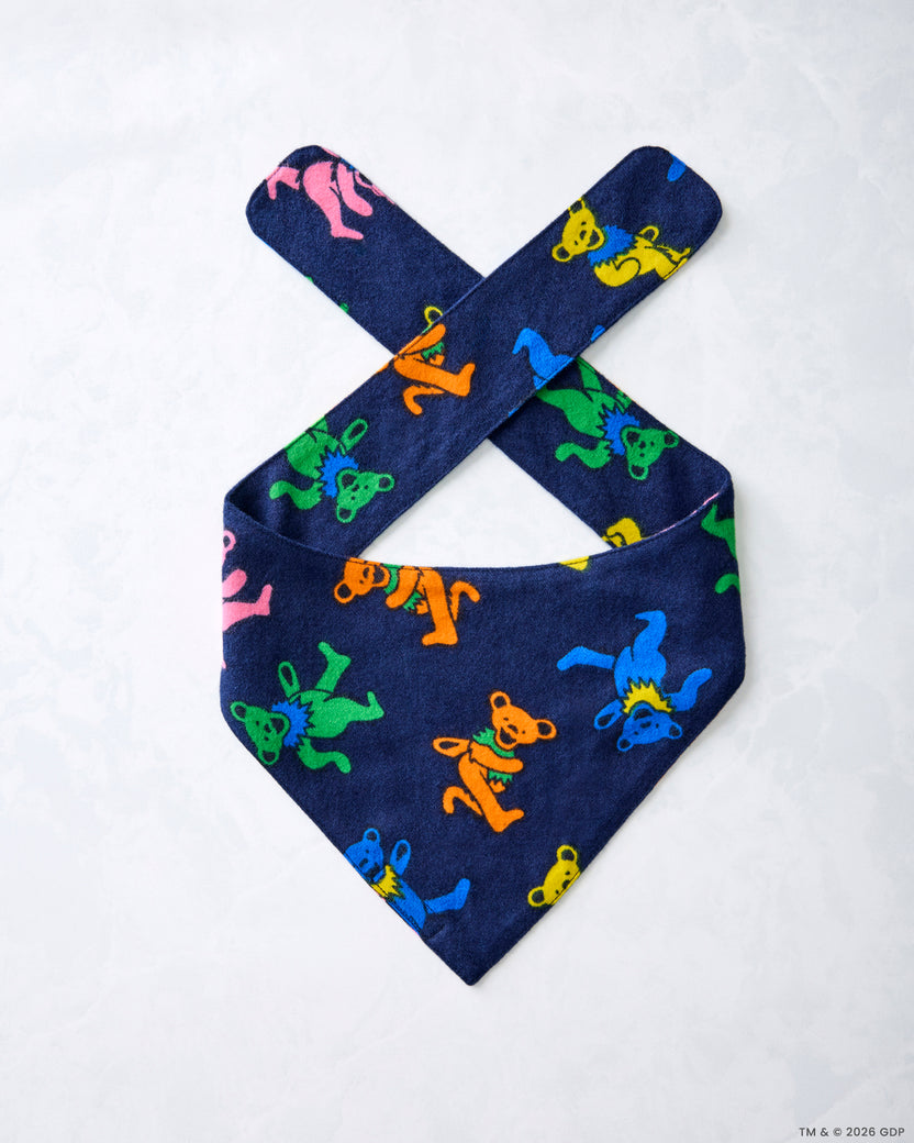 Single navy Dancing Bears pet bandana laid flat, showing crossed tie straps and colorful bear figures.