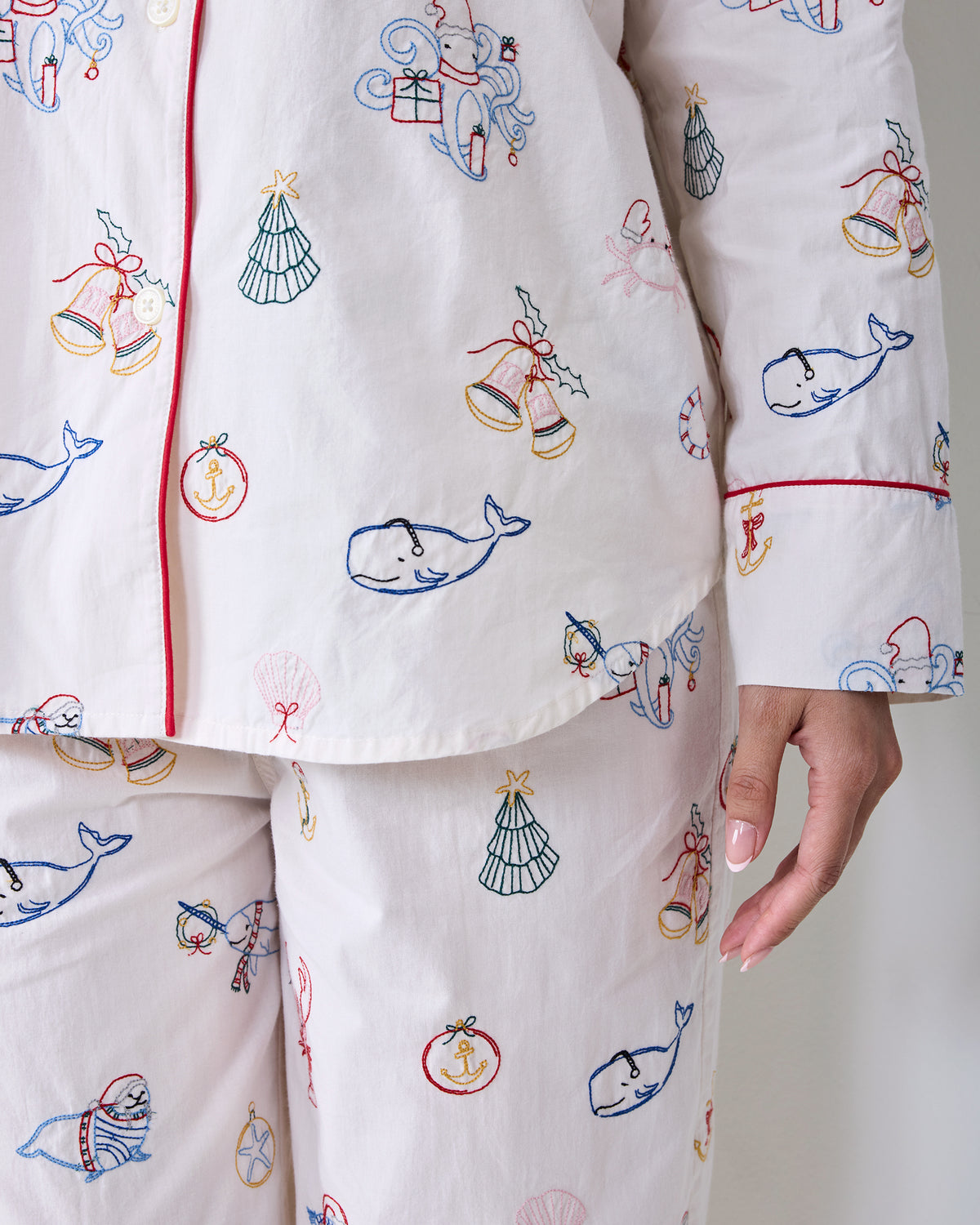 Close-up of the embroidered Yule Tides cloud Long PJ Set showing the button-front top, long sleeve cuff, and matching pants.