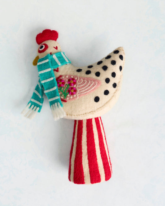 Felt chicken tree topper wearing a turquoise striped scarf, with a floral wing design and red-and-cream striped tail.