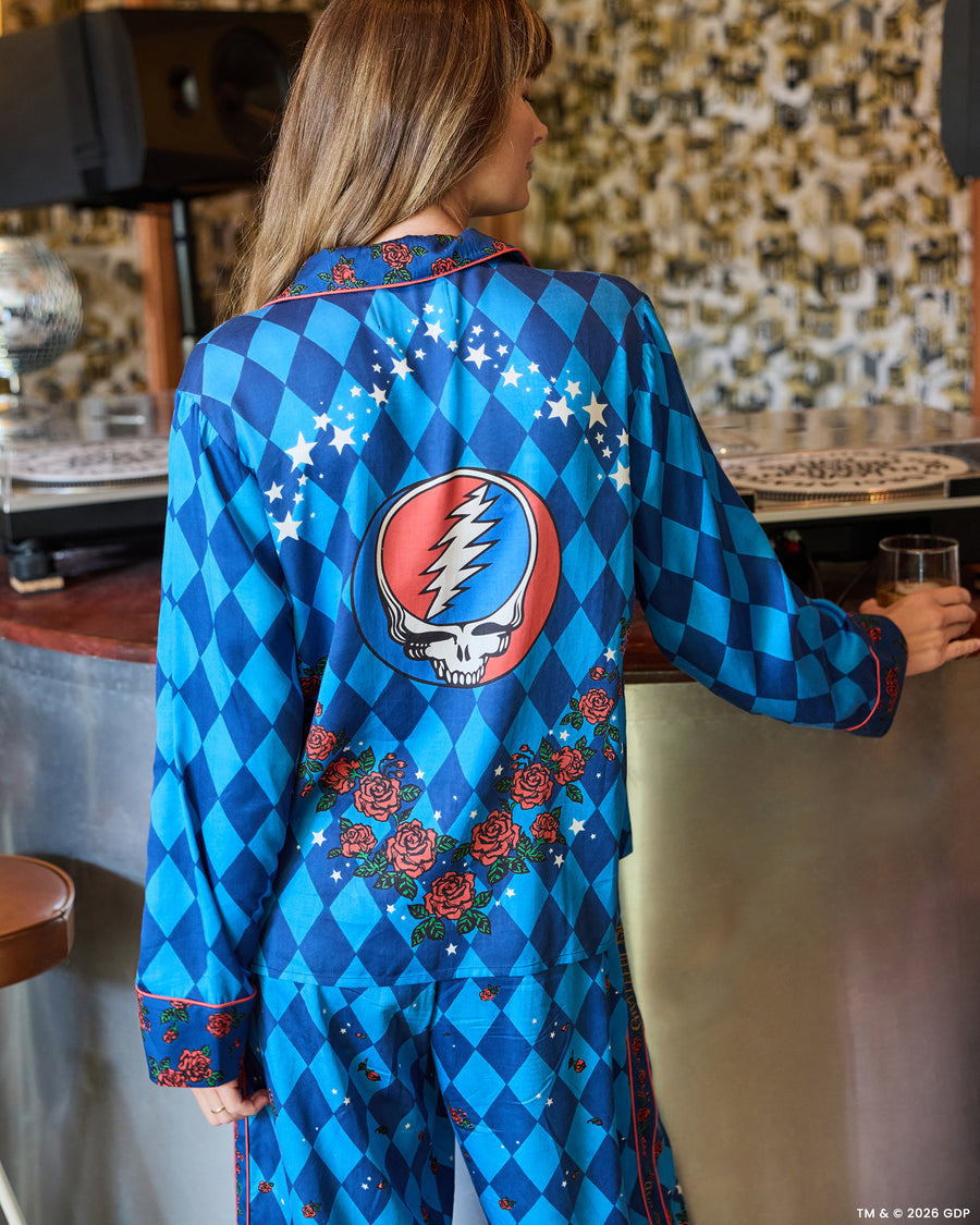 Back view of the blue argyle Soho pajama set with rose trim, stars, and a large skull-and-lightning graphic on the shirt.