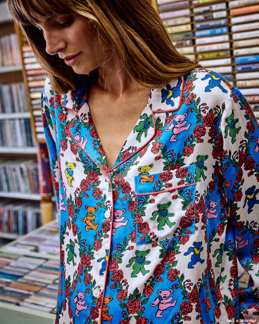 Close-up of the pajama top showing its notched collar, contrasting piping, buttons, and chest pocket.