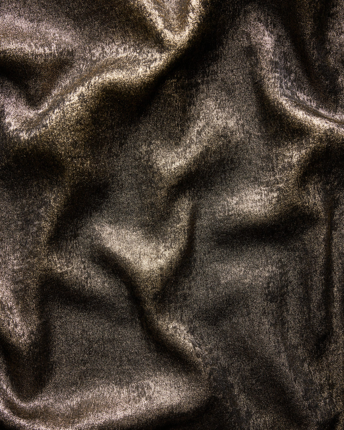Close-up swatch of the Glitzy Lamé gold textile showing its reflective textured surface.