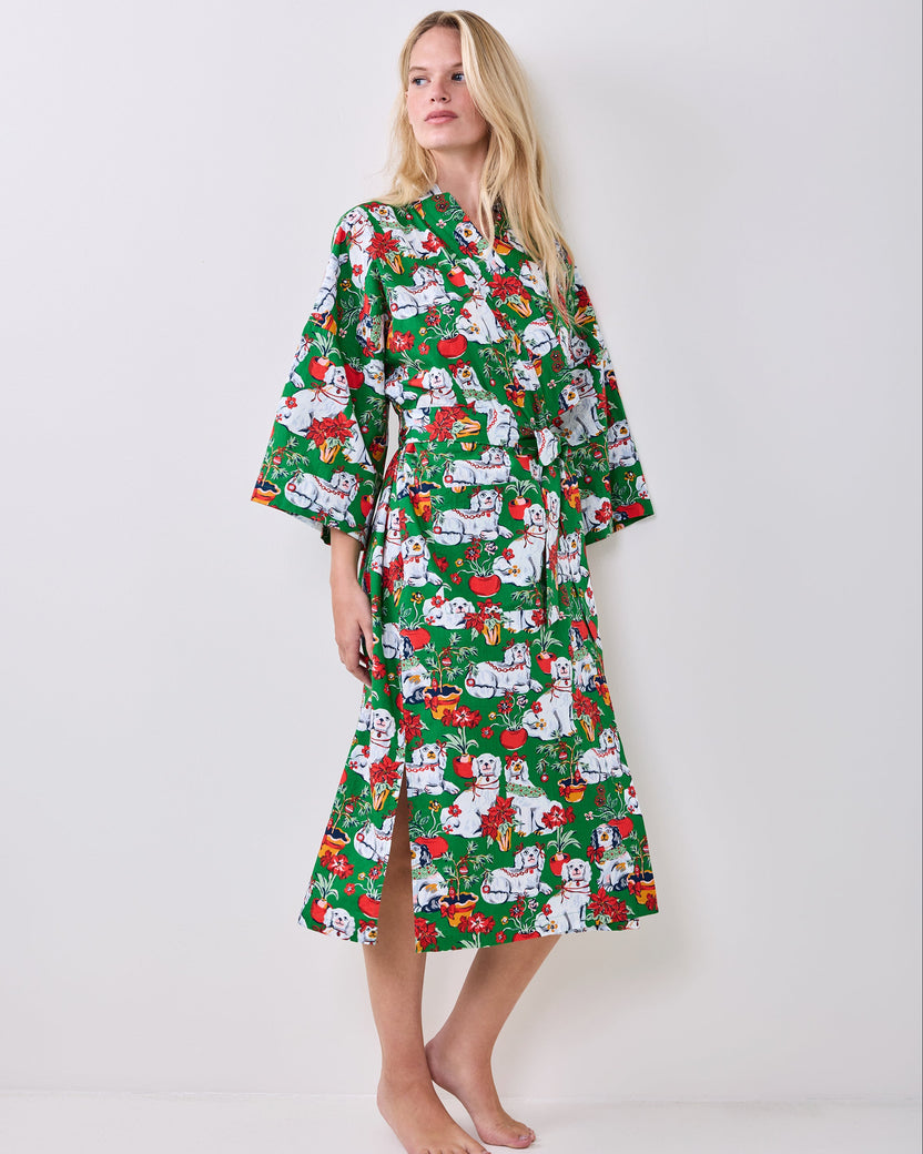Full-length green Good Dog Christmas robe with wide sleeves, a tied belt, and a holiday print of white dogs, poinsettias, and Christmas decorations.