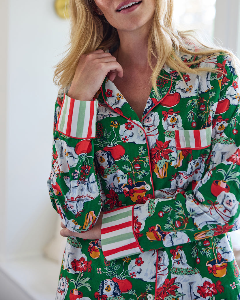 Close-up of the Good Dog Christmas long pajama top, showing the collar, buttons, chest pocket, striped cuffs, and dog-and-poinsettia print.