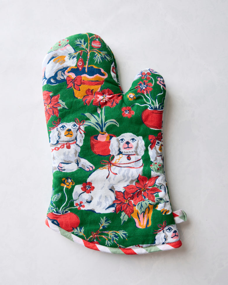 Front of the Good Dog Christmas oven mitt with dog, flower, and holiday ornament illustrations
