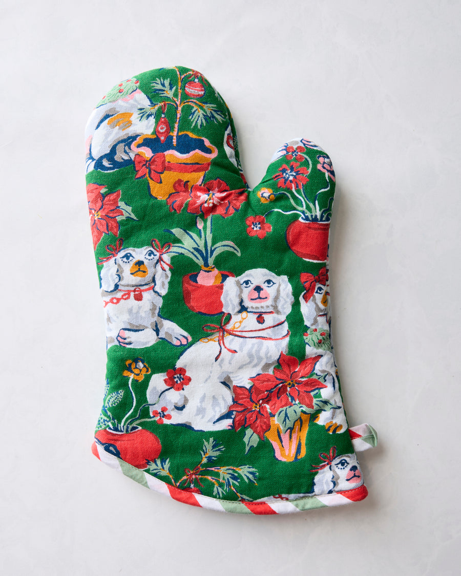 Front of the Good Dog Christmas oven mitt with dog, flower, and holiday ornament illustrations