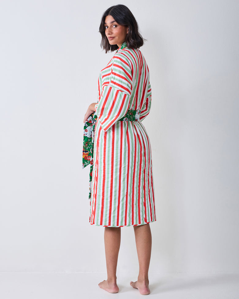 Back view of the Good Dog Christmas reversible quilted robe, showing vertical red, green, and white stripes, a matching belt, and a patterned lining at the sleeve and waist.