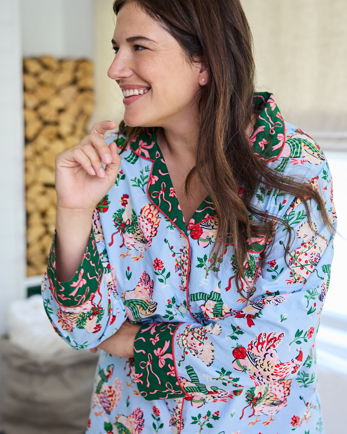 Close-up of the pale blue Holiday Hens pajama top showing the hen print, green contrasting collar and cuffs, and button front.
