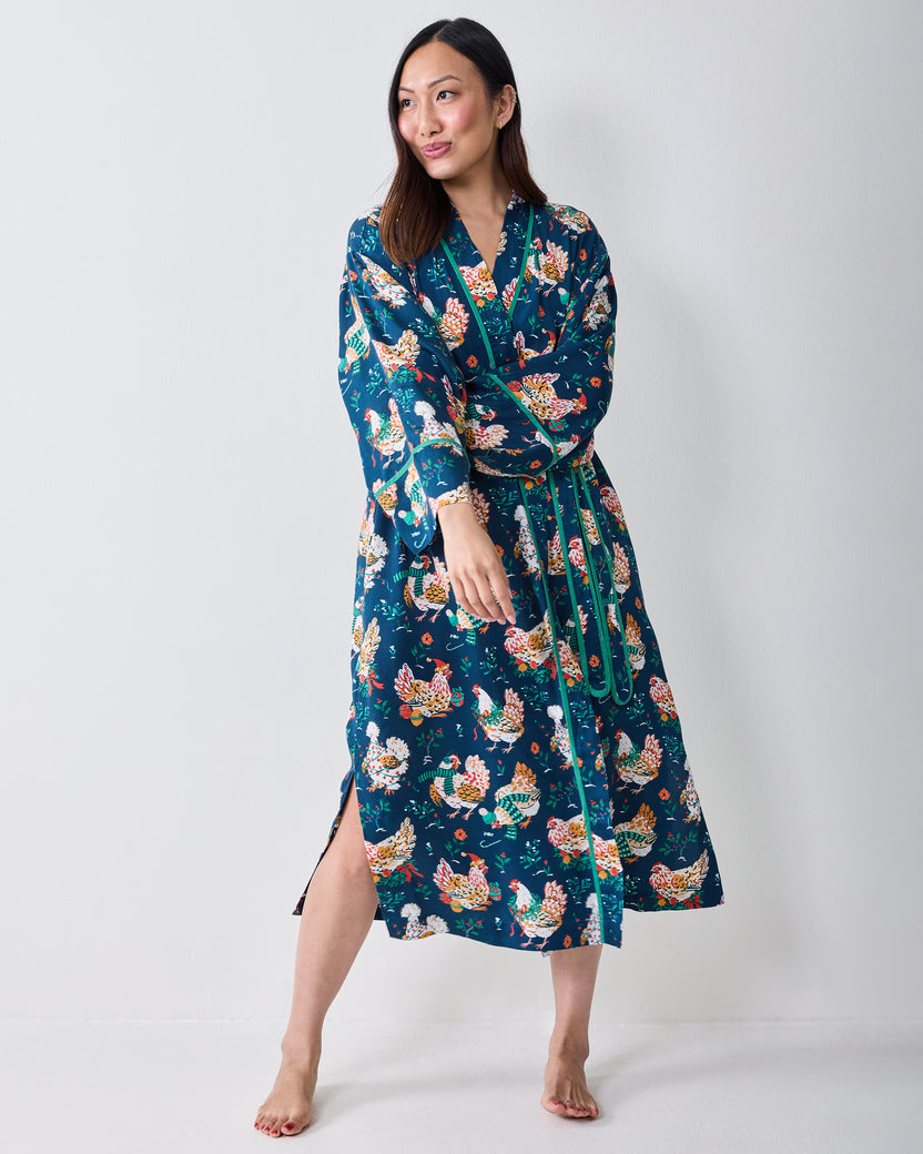 Full-length view of a model wearing the Holiday Hens wrap robe with a contrasting belt and chicken print.