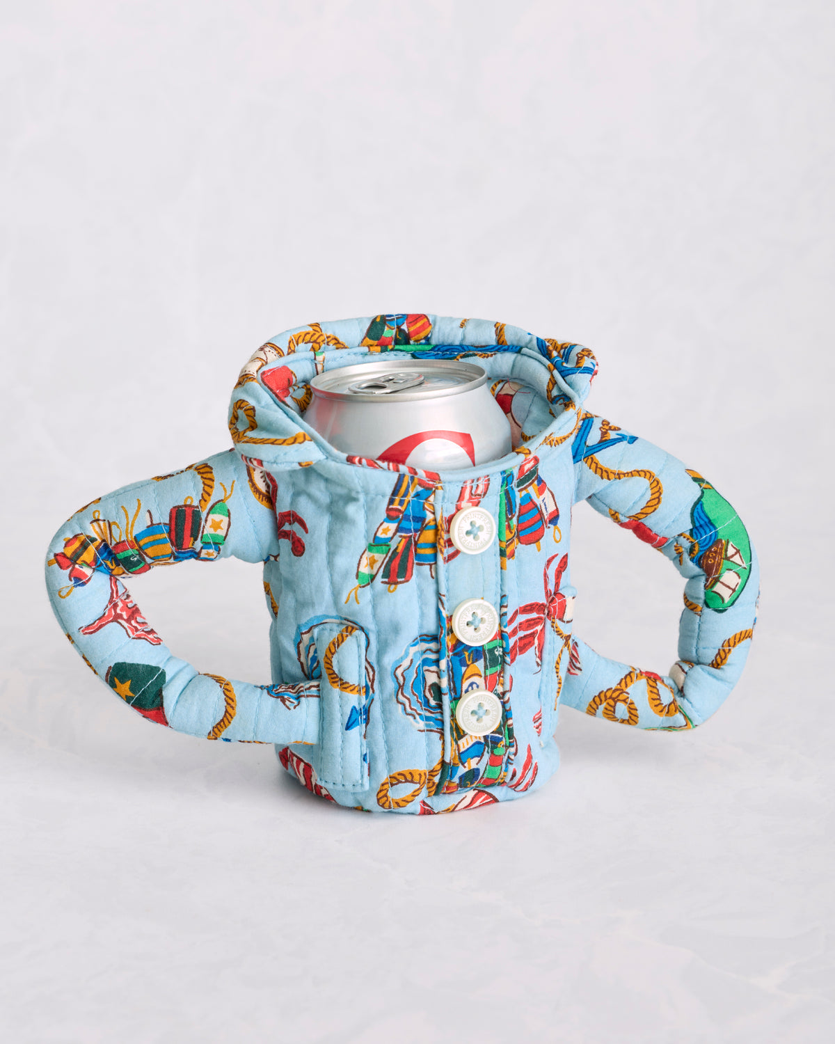 Blue patterned pajama cozie holding a beverage can, with two side handles and a button-up front