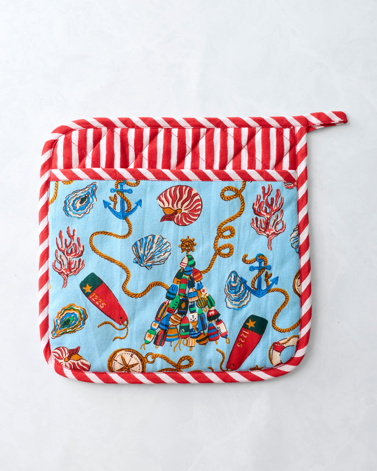 Front of a square pot holder with a blue nautical print, a red-and-white striped border, and a top hanging loop.