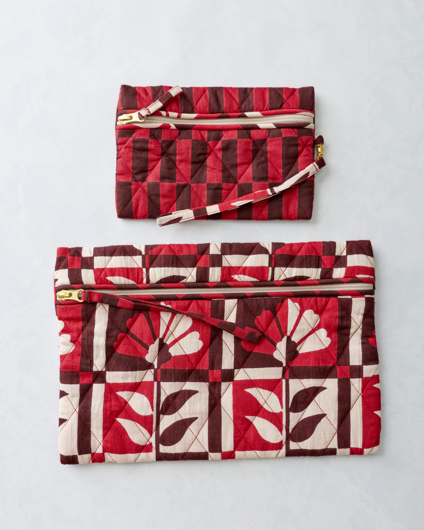 Two quilted zippered pouches in the Poppy print, arranged separately with the smaller pouch above the larger pouch.