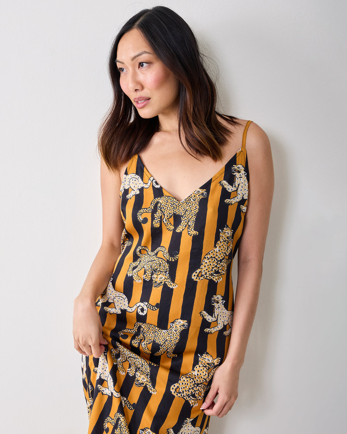 Upper-body view of a model wearing the Leopard Stripes Chic To Sleep nightie, showing its V-neckline, shoulder straps, and leopard print.