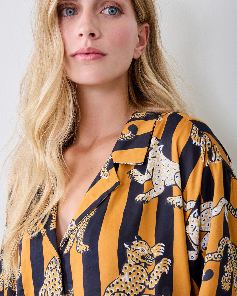 Close-up of the striped leopard-print short-sleeve pajama top with a notched collar and button front.