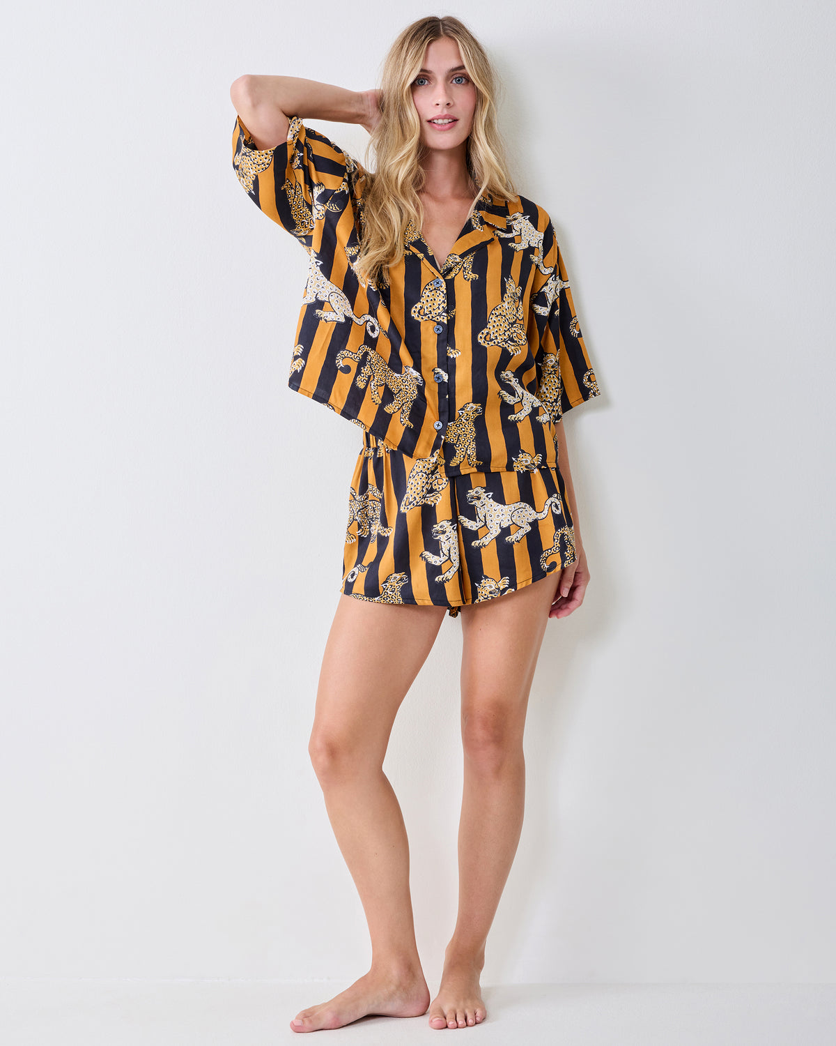 Full-length view of the butterscotch Leopard Stripes short-sleeve top and shorts set with a button-front shirt and leopard print.