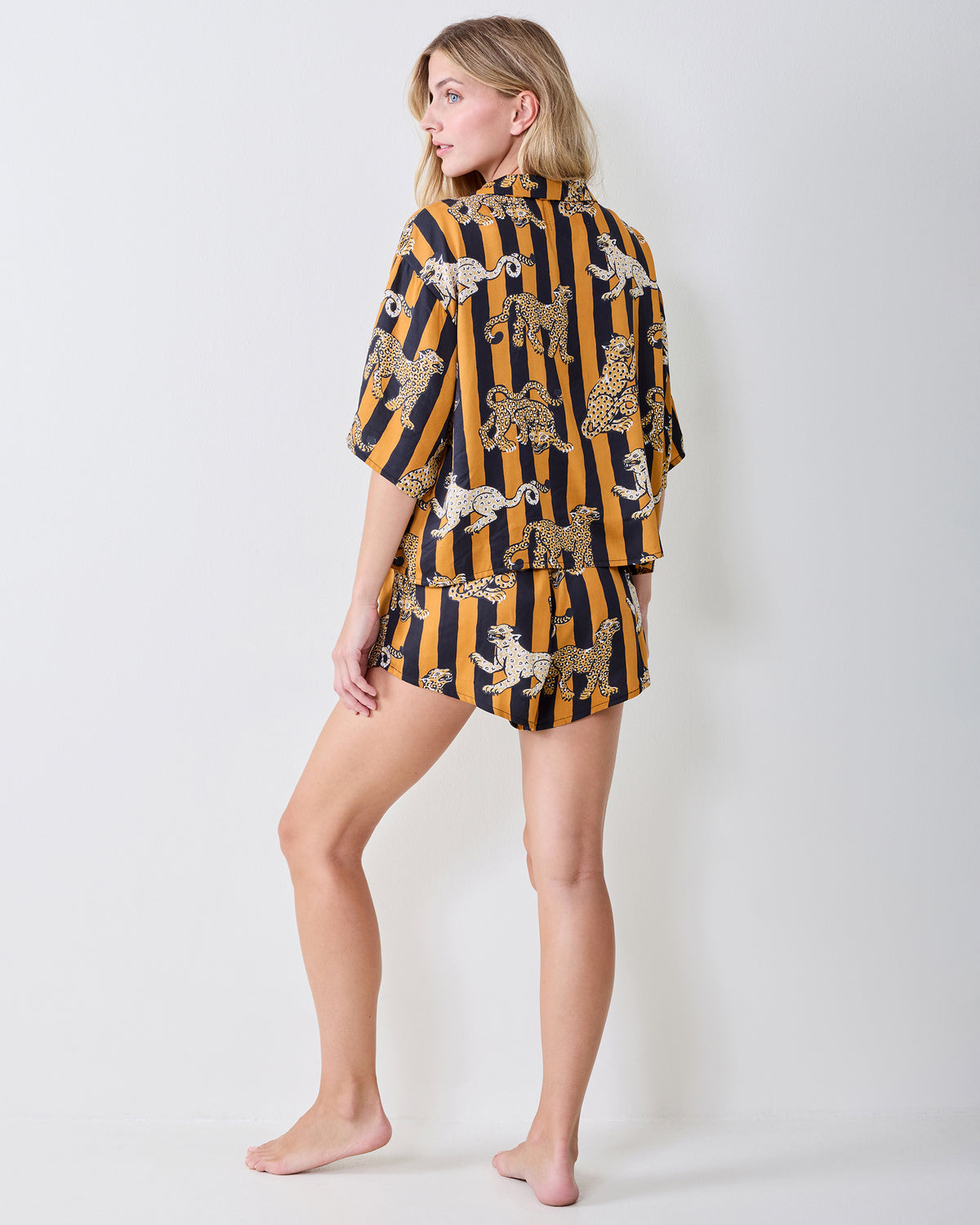 Back view of the striped leopard-print short-sleeve pajama set with a top and shorts.