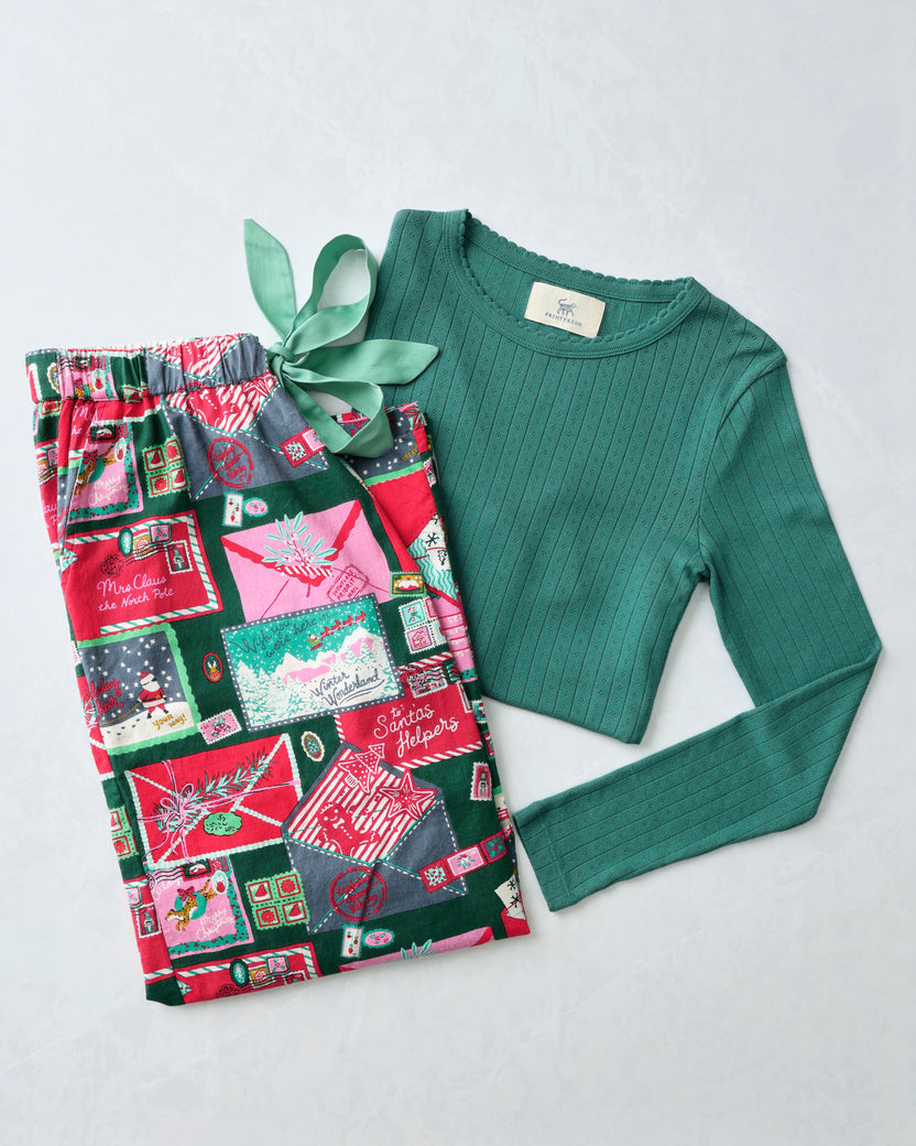 Letters to Santa pajama bundle with patterned pants and a green long-sleeve pointelle top.