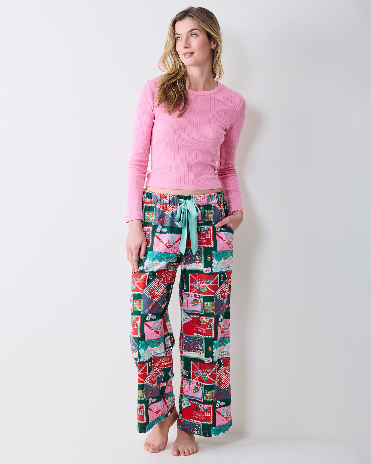 Front view of Letters to Santa lightweight flannel pajama pants with an elastic waist and satin tie.