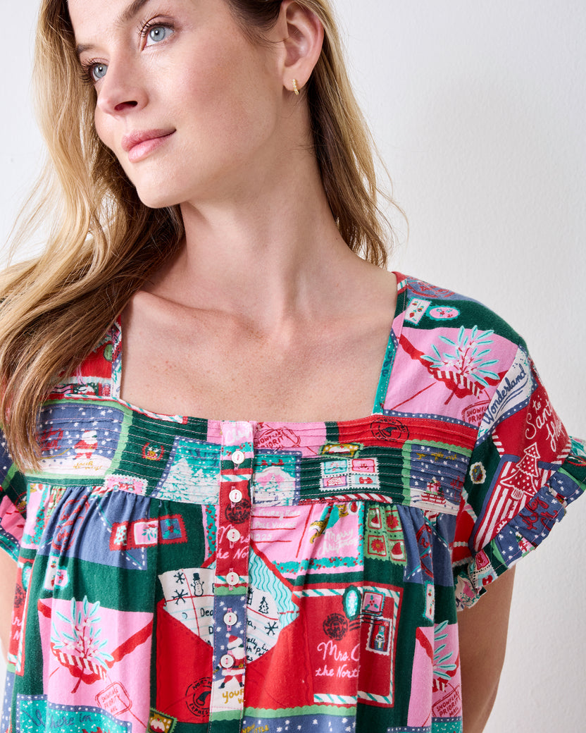 Close front view of the Letters to Santa flannel nightgown showing its square neckline, button placket, short sleeves, and holiday card print.