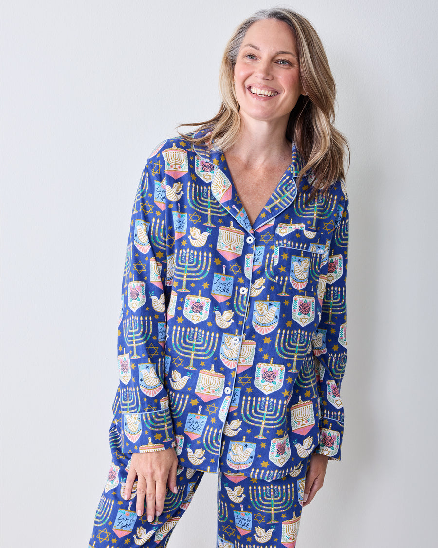Full-length front view of a person wearing the blue Love & Light Hanukkah-print long pajama set.
