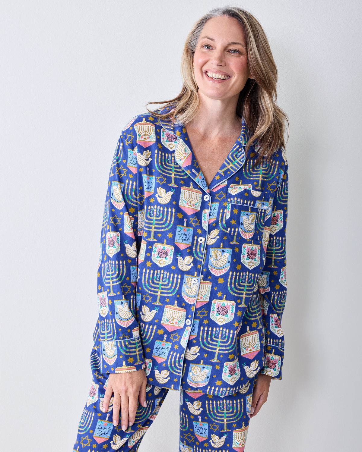 Close-up of a person wearing a blue printed pajama shirt and matching pants