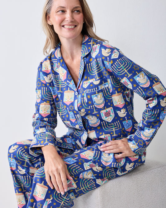 Seated model wearing the Love & Light long flannel pajama set with a button-down top and matching pants.