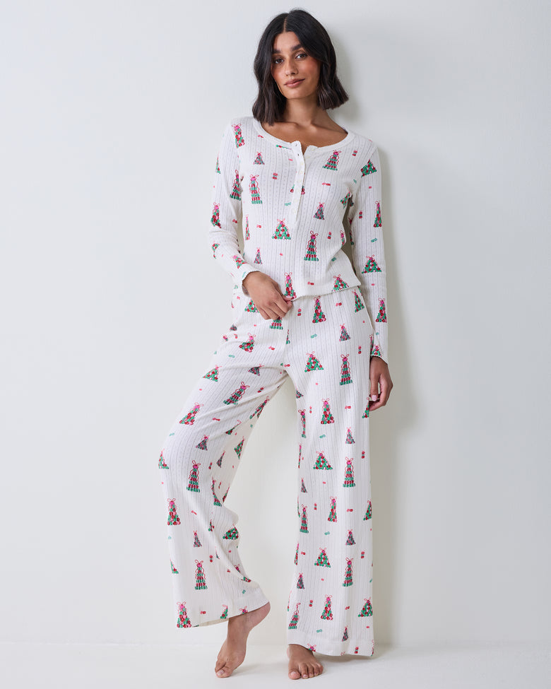 Full front view of the buttercream Kaylee Set with a long-sleeved top and wide-leg pants covered in a colorful macaron tower print.