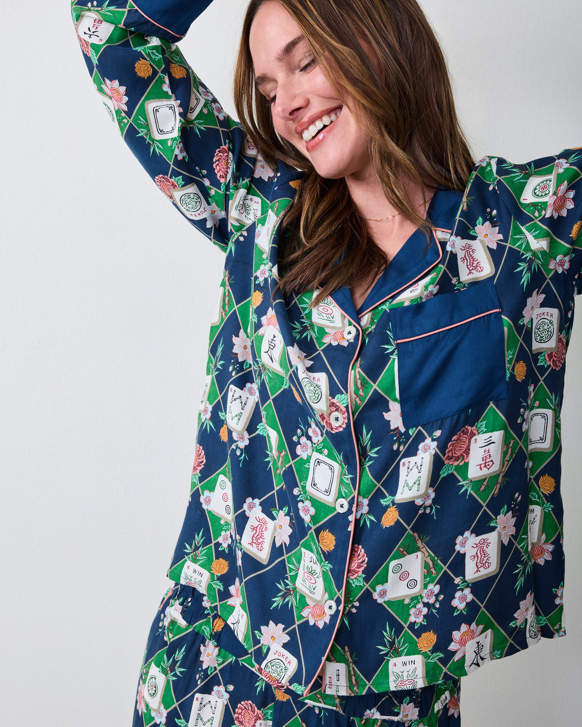 Mahj Garden Soho pajama top and pants in a dark blue, green, and floral tile print, shown from the front.
