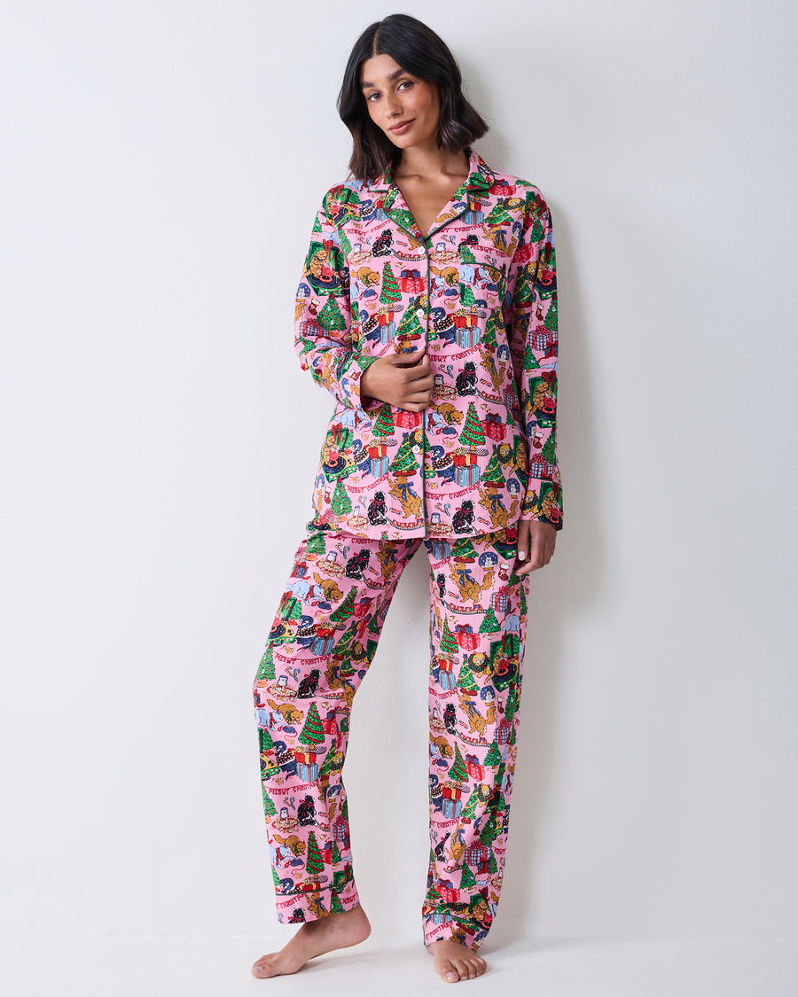 Three-quarter front view of the candy pink long pajama set with a collared button-front top and matching Christmas cat print.