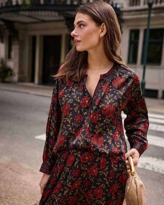 Angled front view of the Midwinter Bloom Drew blouse showing the V-neckline, button placket, long sleeves, and floral print.