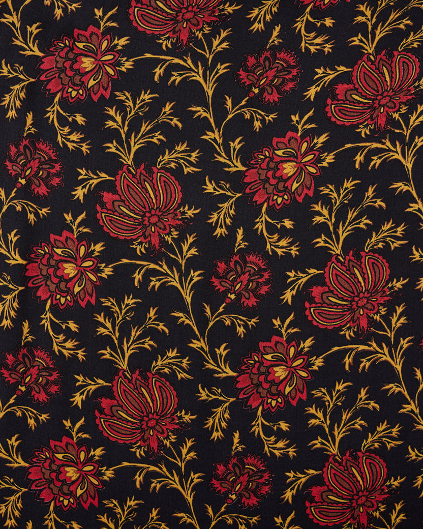 Close-up of the Midwinter Bloom floral print with red and gold flowers and leaves on a dark background.