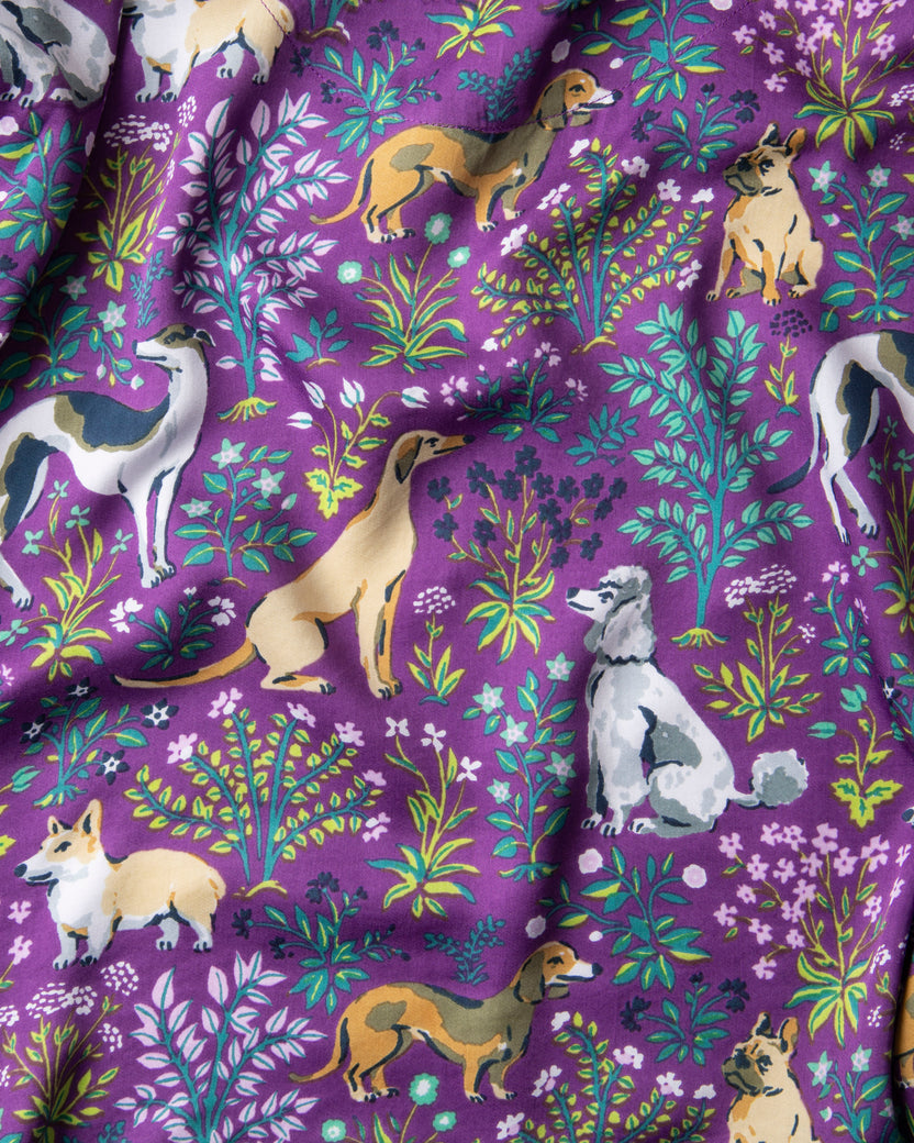 Amethyst fabric swatch with illustrated dogs and colorful botanical motifs.