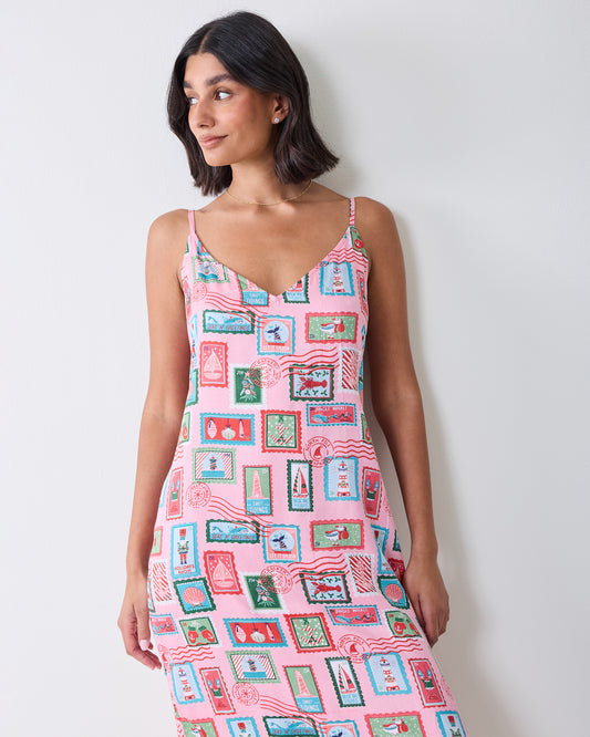 Front close-up of a person wearing the pink Nautical Stamps Eco Satin Chic To Sleep Nightie, showing the V-neckline and printed pattern.