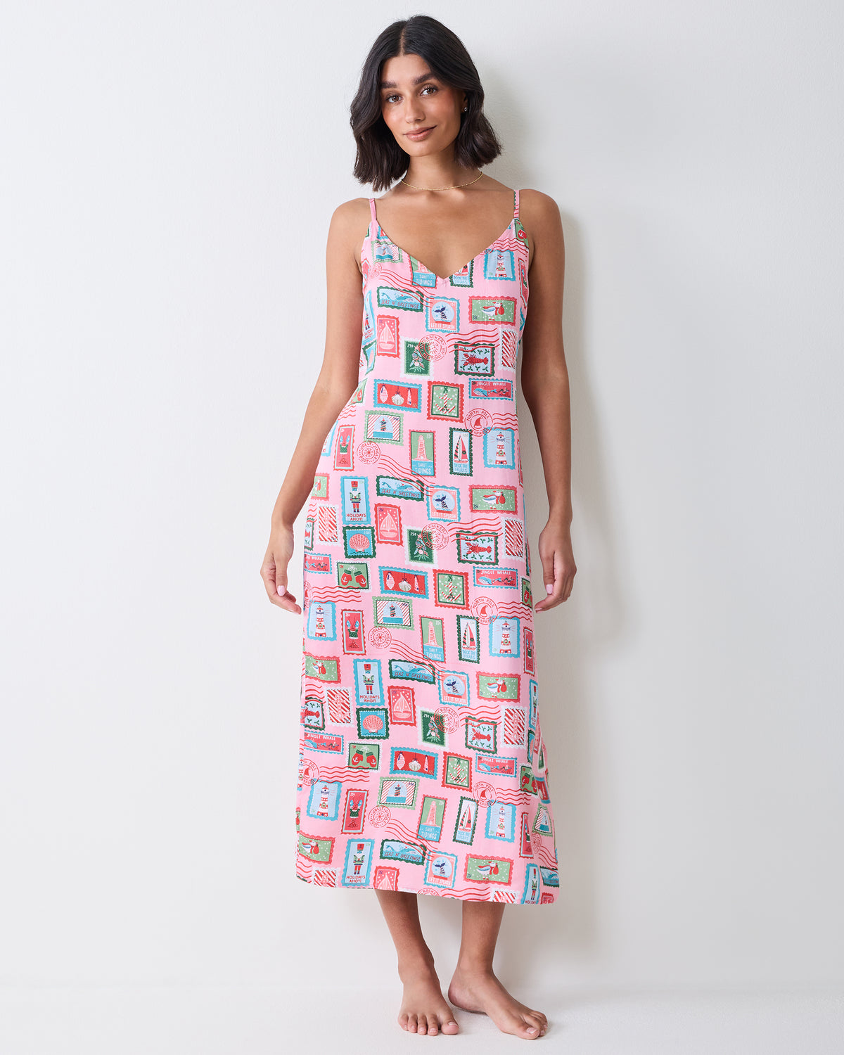 Full-length front view of a person wearing the pink Nautical Stamps Eco Satin Chic To Sleep Nightie against a light wall.