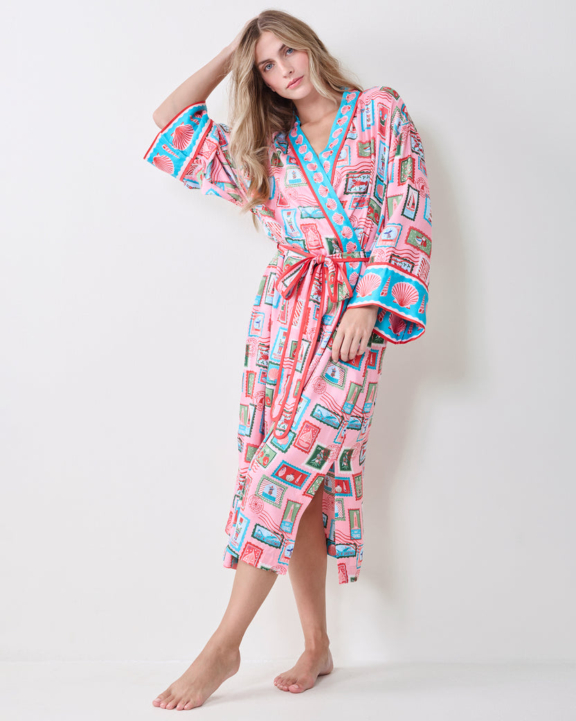 Full-length front view of a person wearing the pink Nautical Stamps Eco Satin Robe with a belted wrap front and side slit.
