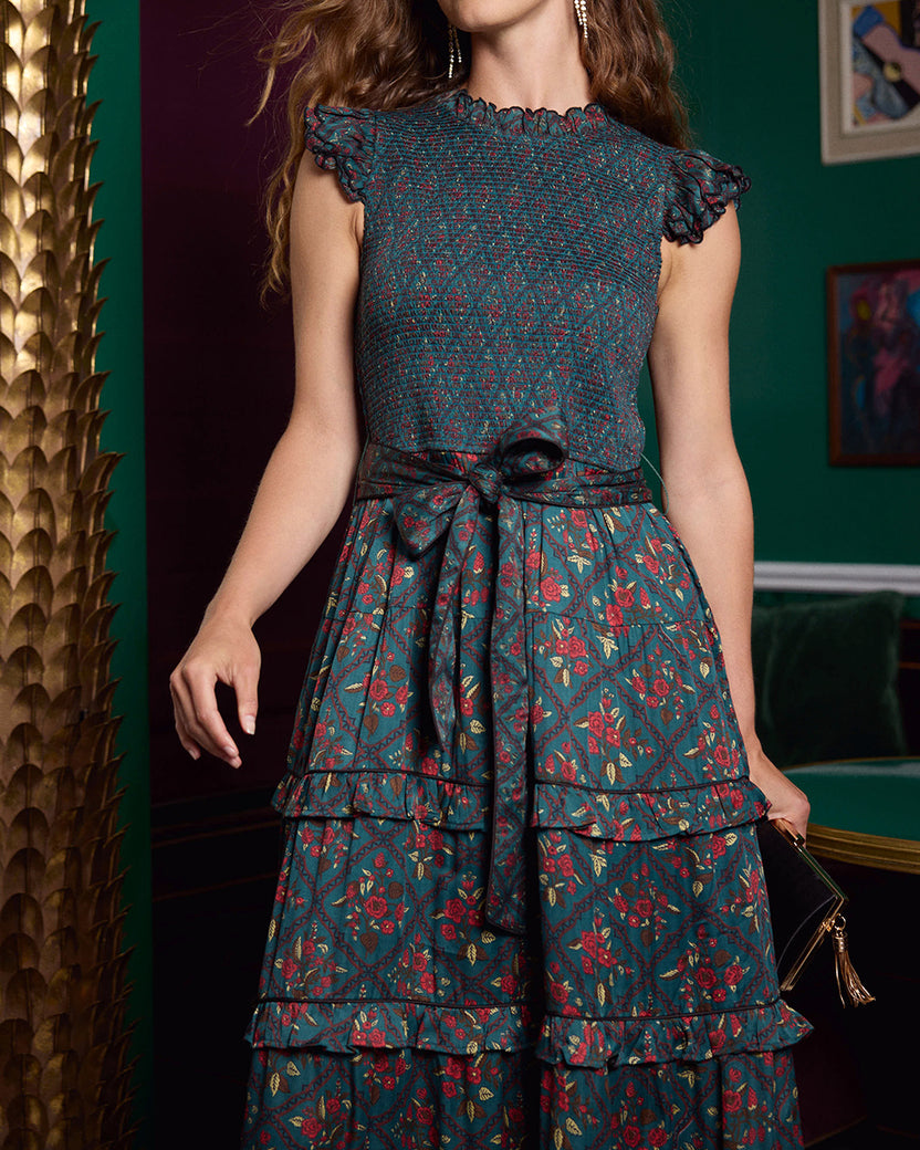 Close-up of the Ready to Ruffle Maxi showing its smocked bodice, ruffled sleeves, tied waist, and tiered floral-patterned skirt.