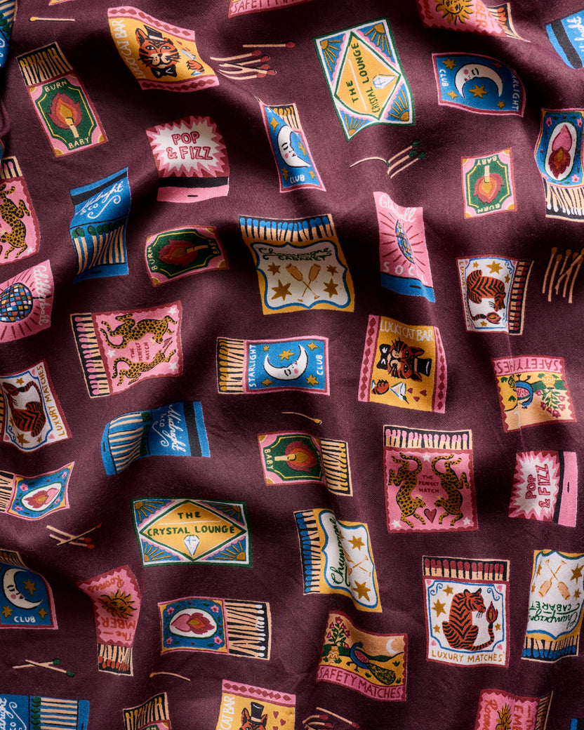 Close-up of the Painted Matchbook print on the Cabernet Eco Satin robe.
