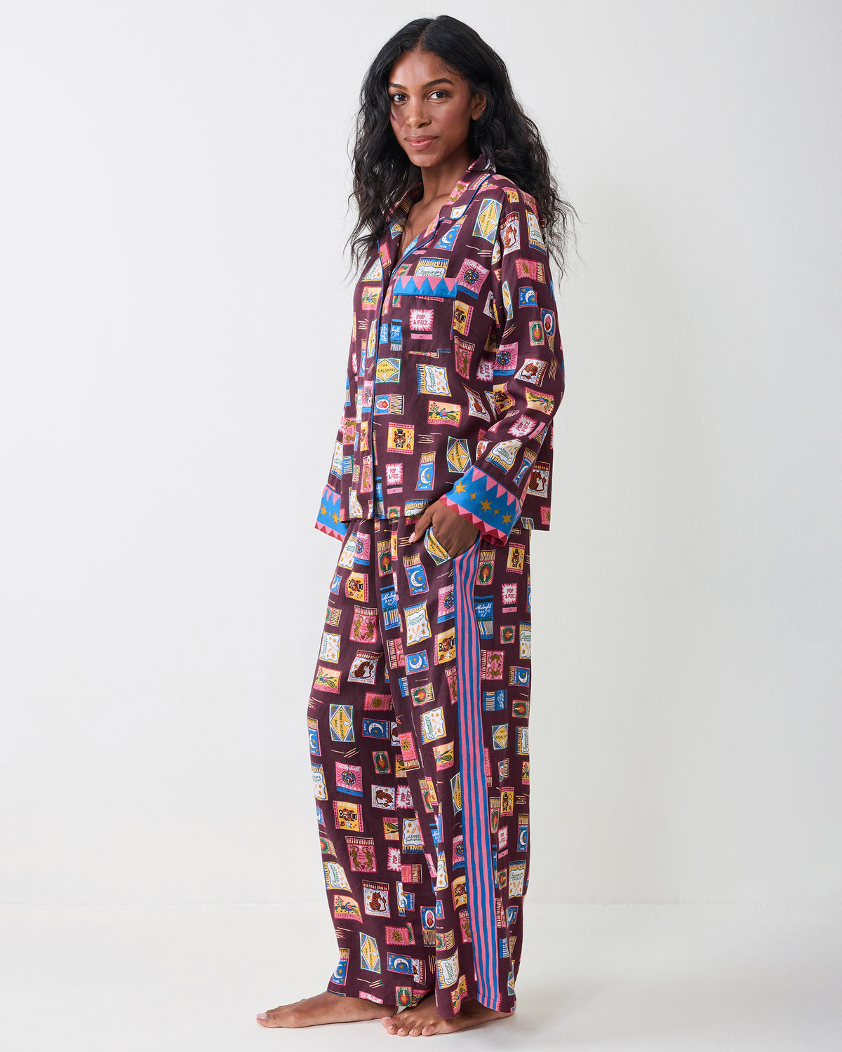 Side view of the Painted Matchbook Cabernet pajama set, showing the button-down top, wide-leg pants, and striped side detail.