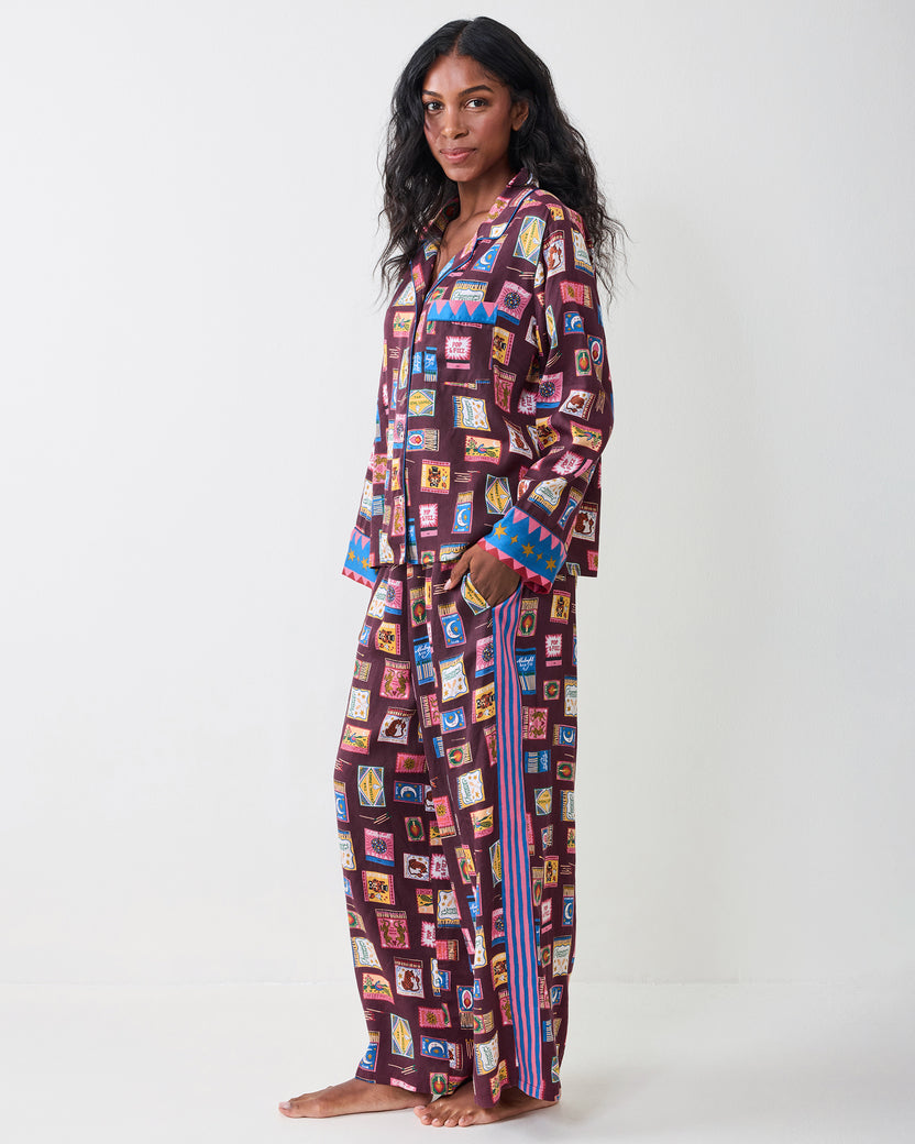 Side view of the Painted Matchbook Cabernet pajama set, showing the button-down top, wide-leg pants, and striped side detail.